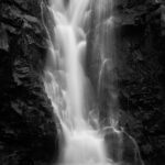 grayscale photo of waterfalls during daytime